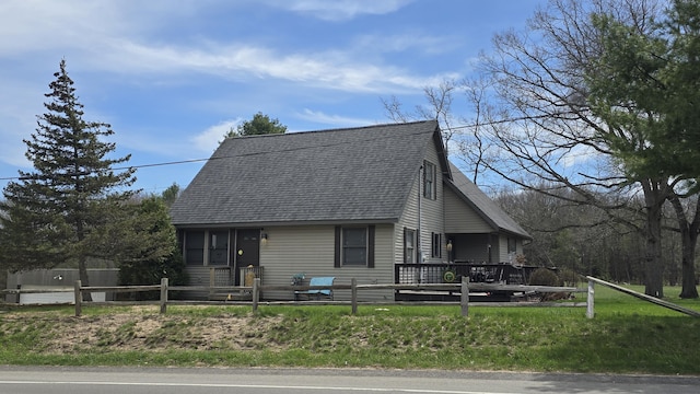 view of front of property with a shingled roof and fence private yard