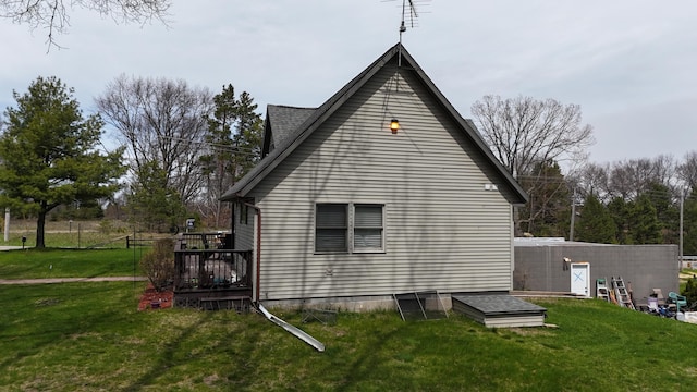 view of home's exterior featuring a yard and a wooden deck