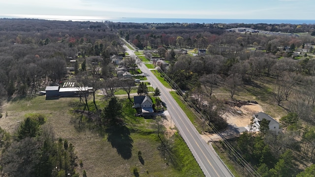 birds eye view of property featuring a view of trees