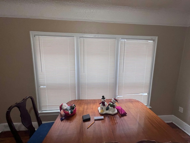 dining area with crown molding and a textured ceiling