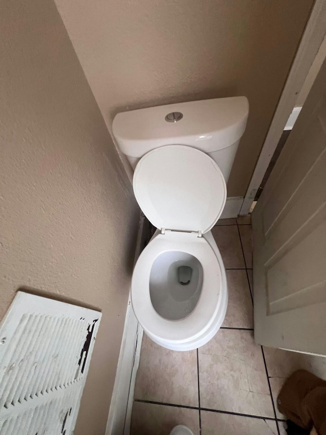 bathroom featuring tile patterned flooring and toilet