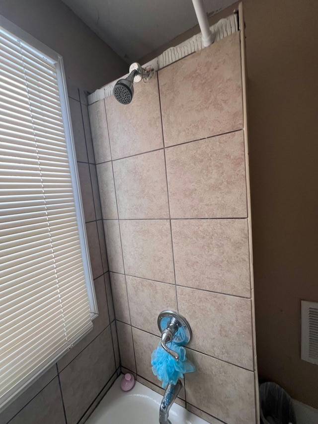 interior details featuring tiled shower / bath