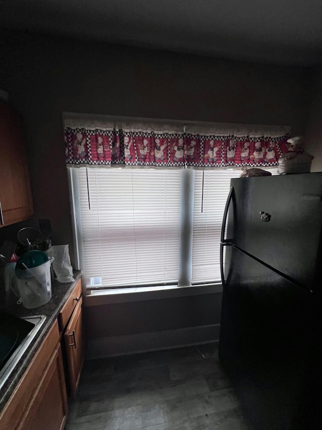 kitchen featuring black refrigerator and sink