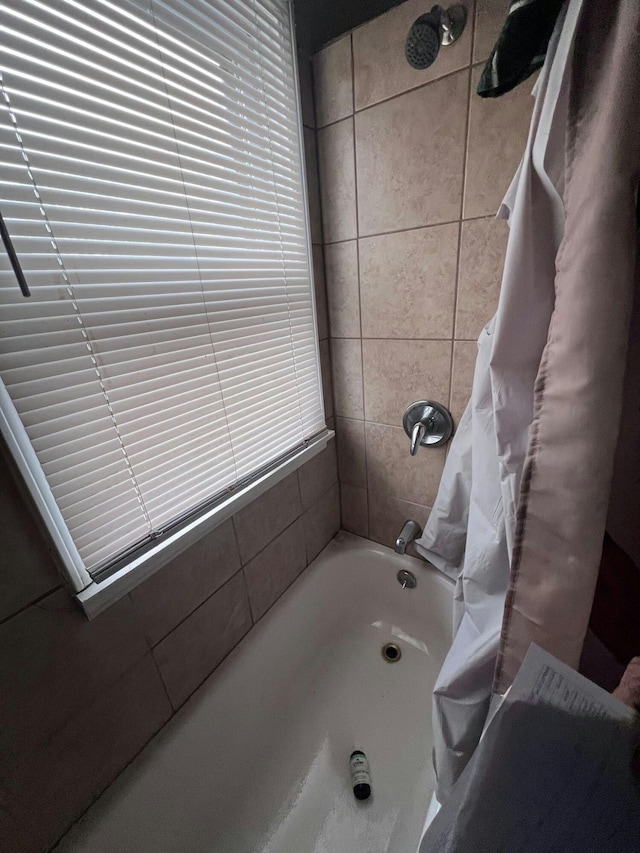 bathroom with shower / bath combo with shower curtain