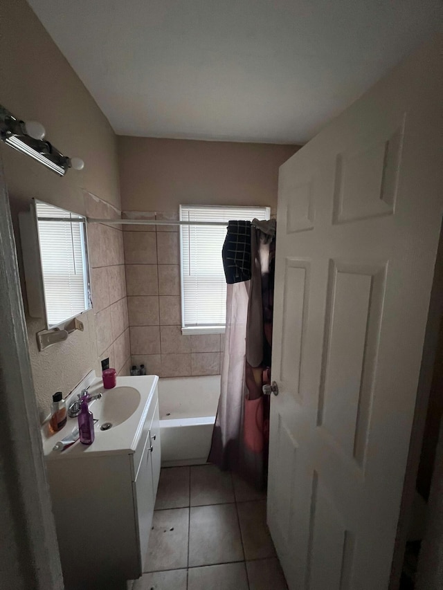 bathroom featuring tile patterned flooring, vanity, and shower / bath combo