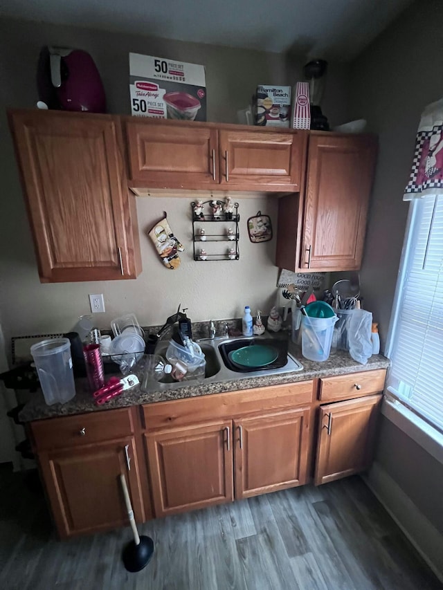 kitchen featuring hardwood / wood-style floors and stone counters