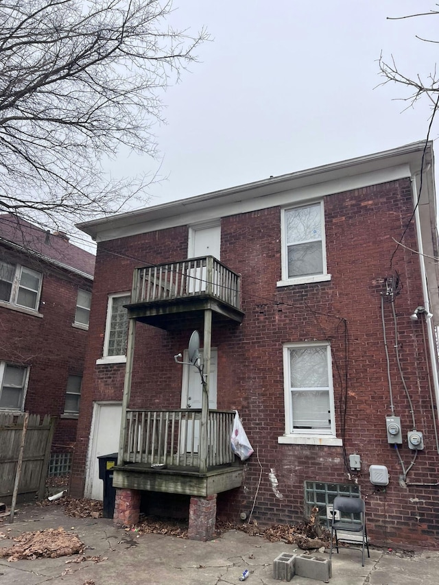 back of property with a balcony