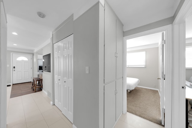 hallway featuring light tile patterned flooring