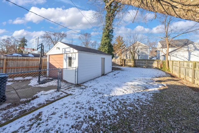 yard covered in snow with a storage shed