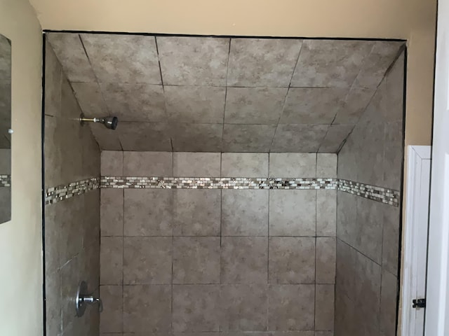 bathroom with tiled shower