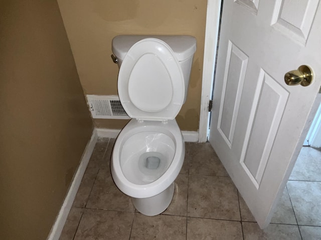 bathroom with toilet and tile patterned flooring