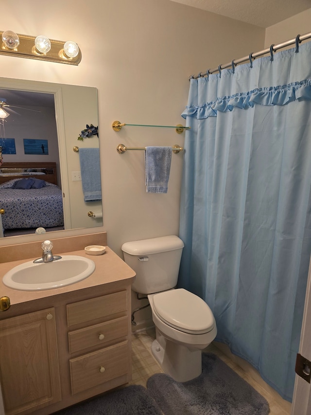 bathroom with walk in shower, vanity, and toilet