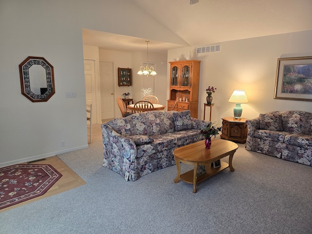 living room featuring an inviting chandelier, carpet flooring, and vaulted ceiling