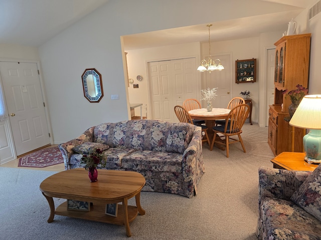 living room featuring a notable chandelier, vaulted ceiling, and light colored carpet