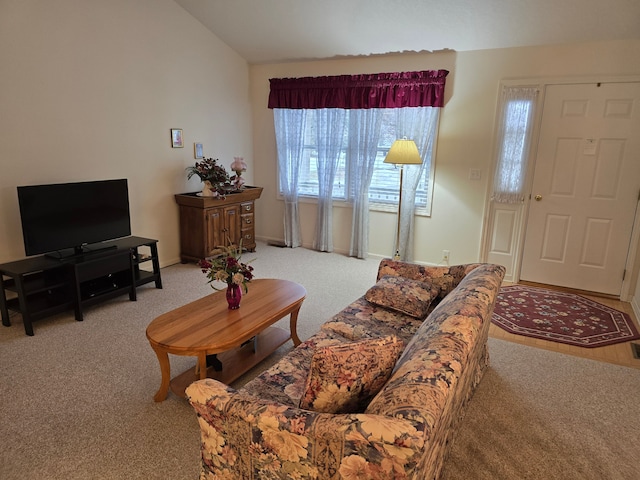 living room featuring lofted ceiling and light colored carpet