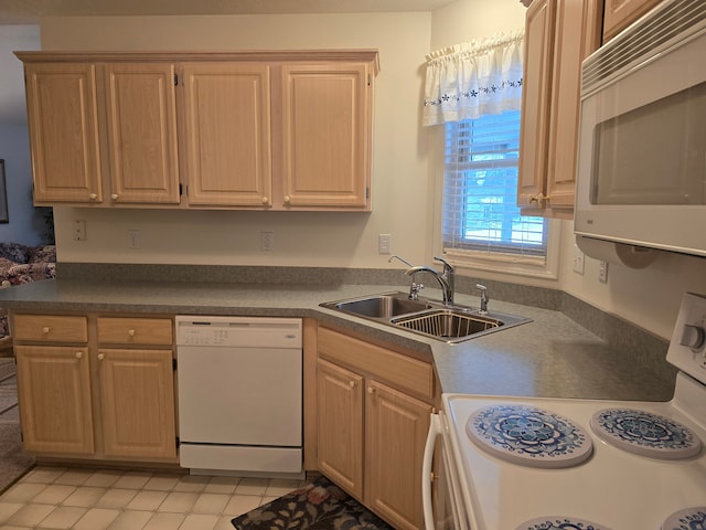 kitchen featuring sink, white appliances, and light brown cabinets