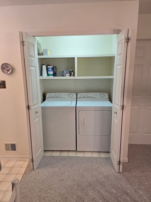 washroom with light carpet and washing machine and clothes dryer