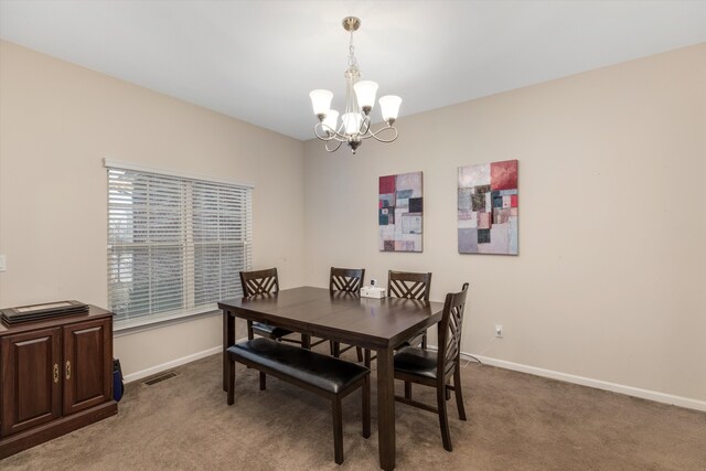 dining space featuring an inviting chandelier and carpet