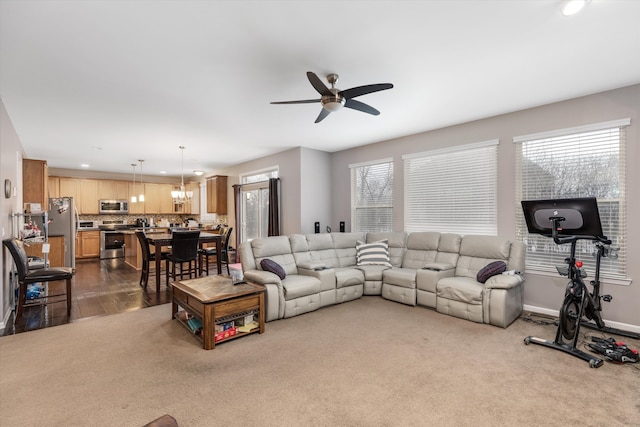 living room featuring ceiling fan and carpet