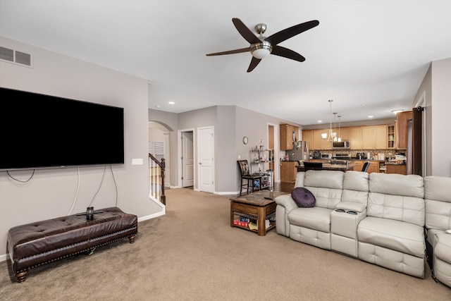 carpeted living room featuring ceiling fan