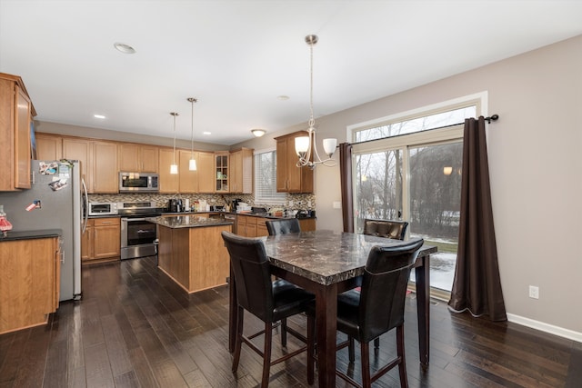 dining room featuring a notable chandelier and dark hardwood / wood-style flooring