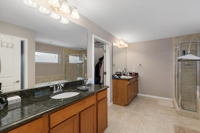 bathroom featuring vanity and shower with separate bathtub