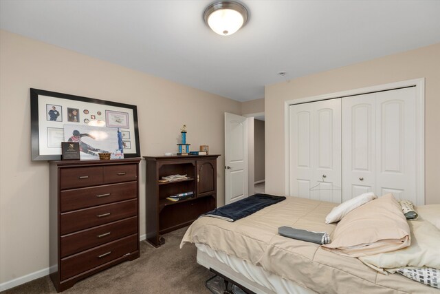 bedroom featuring dark carpet and a closet