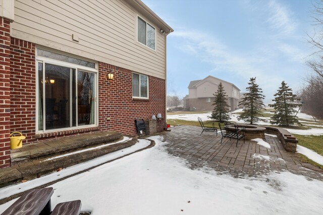 view of snow covered exterior featuring a patio