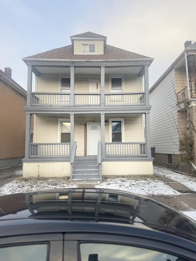 view of front of home featuring a porch and a balcony