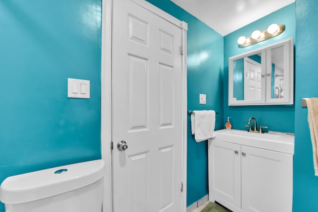 bathroom featuring toilet and vanity