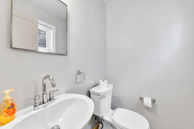 half bath featuring a sink and toilet