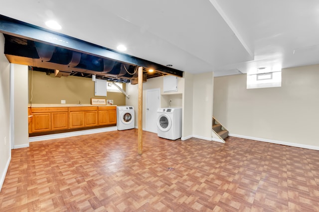 below grade area with baseboards, stairs, washer / clothes dryer, and a sink