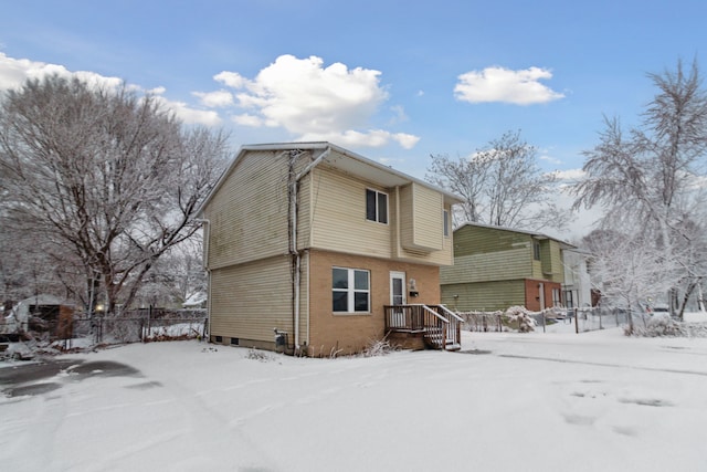 view of snow covered rear of property