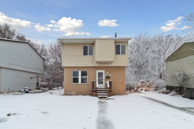 view of snow covered rear of property