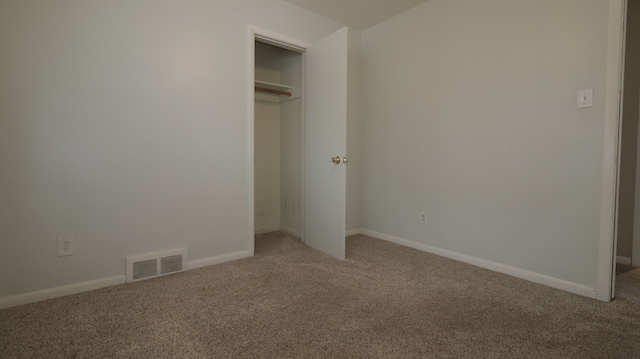 unfurnished bedroom featuring a closet and carpet