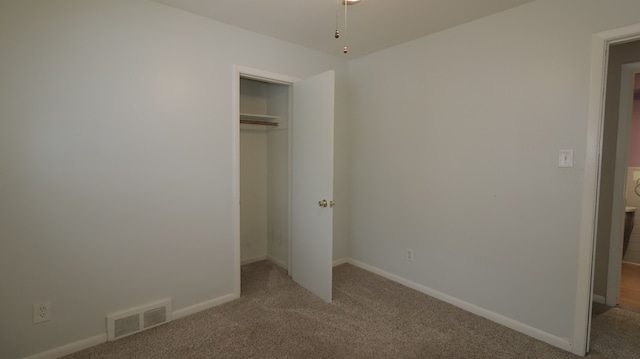 unfurnished bedroom with carpet floors and a closet