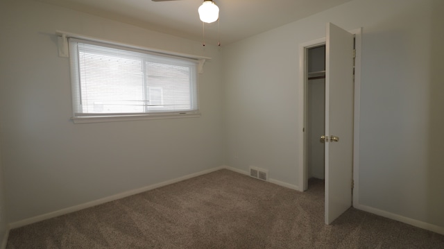 unfurnished bedroom featuring carpet flooring and a closet