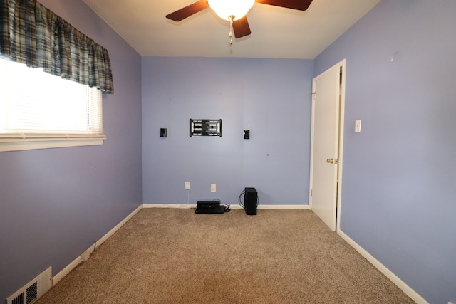 interior space with carpet and ceiling fan