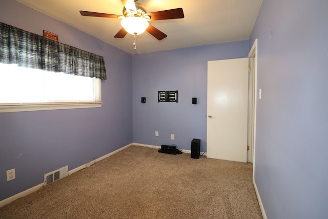 carpeted spare room featuring ceiling fan