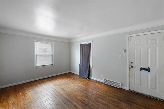 spare room featuring dark hardwood / wood-style flooring