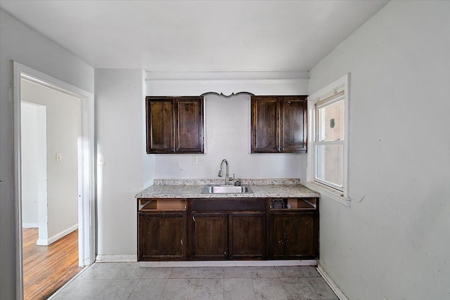 kitchen featuring sink and dark brown cabinets