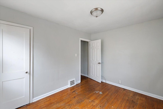 empty room featuring dark wood-type flooring