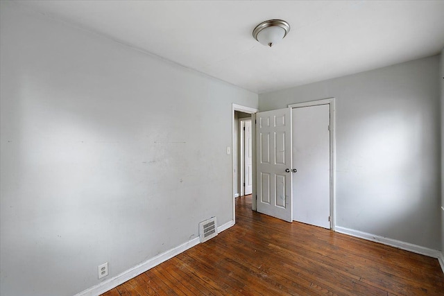 spare room with dark hardwood / wood-style floors