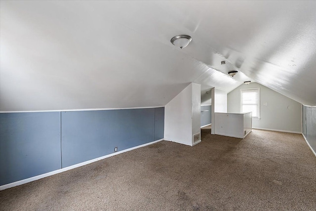 additional living space with lofted ceiling and carpet