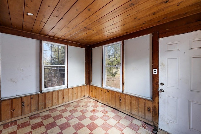 unfurnished sunroom with a wealth of natural light and wooden ceiling