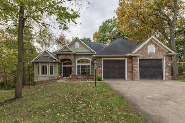 view of front of house featuring a garage and a front yard