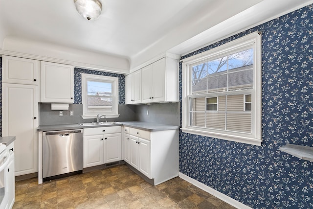 kitchen with stove, sink, stainless steel dishwasher, and white cabinets