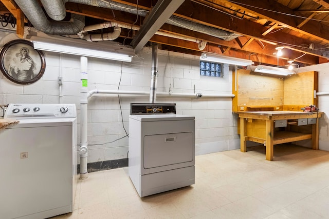 washroom featuring washer and dryer and a workshop area