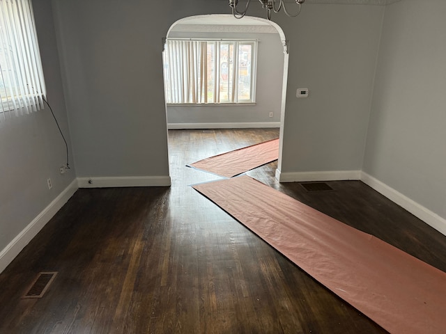 unfurnished room featuring dark wood-type flooring