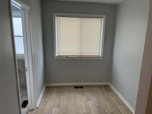 spare room with light hardwood / wood-style floors